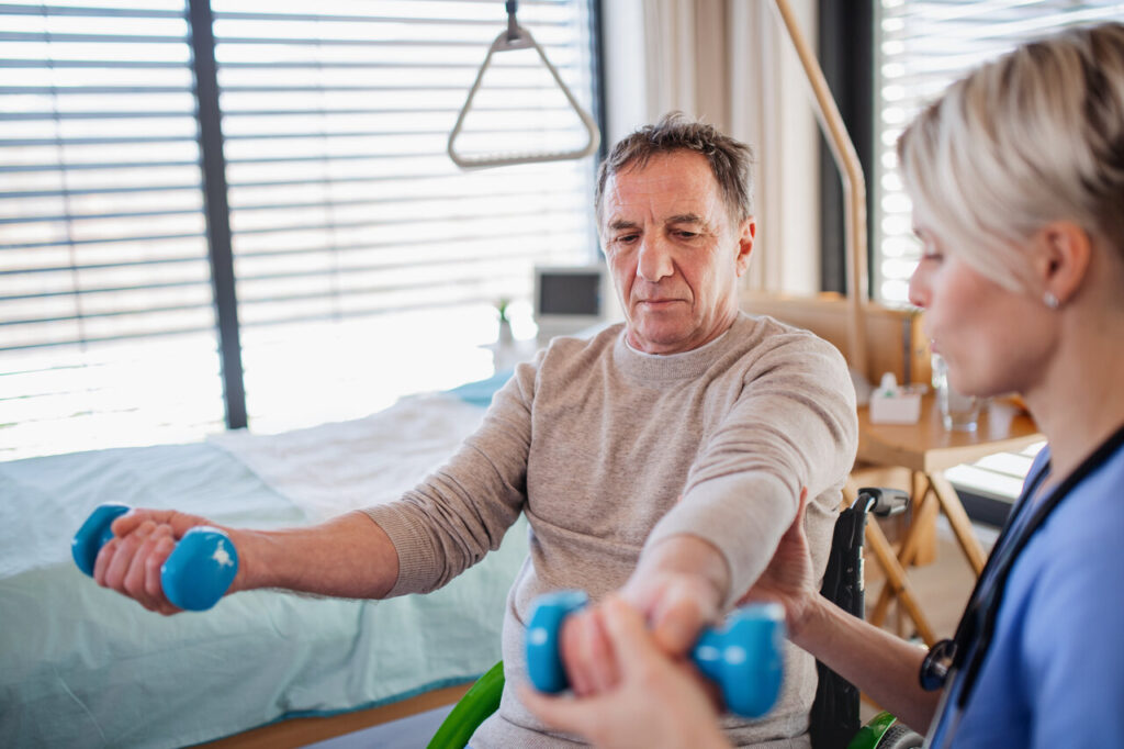 a healthcare worker and senior patient in hospital, physiotherapy.
