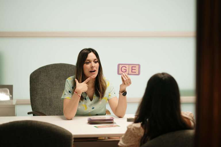speech therapist works with young child patient
